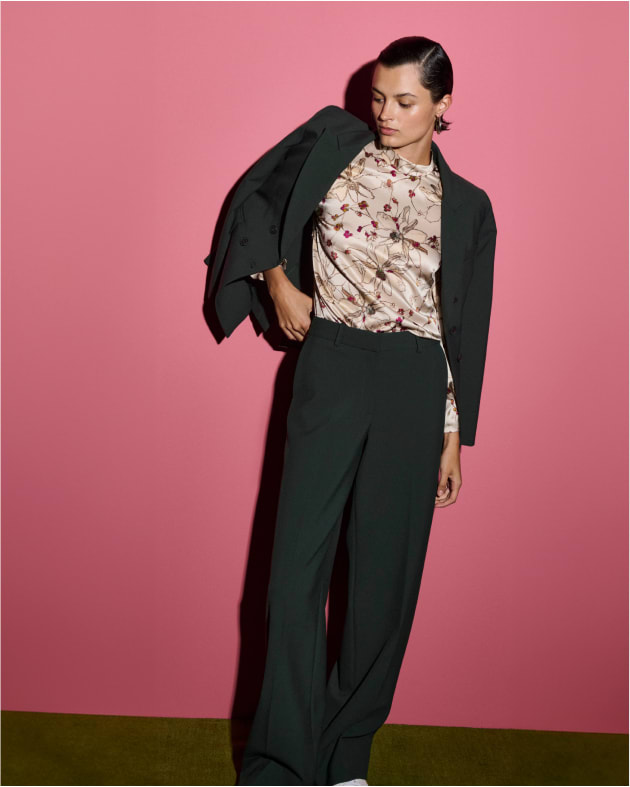 image of a woman wearing a dark emerald suit