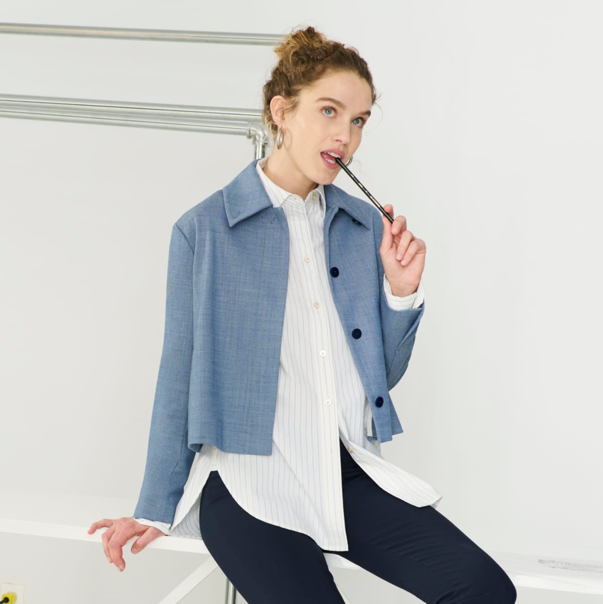 image of a woman sitting in a blue jacket