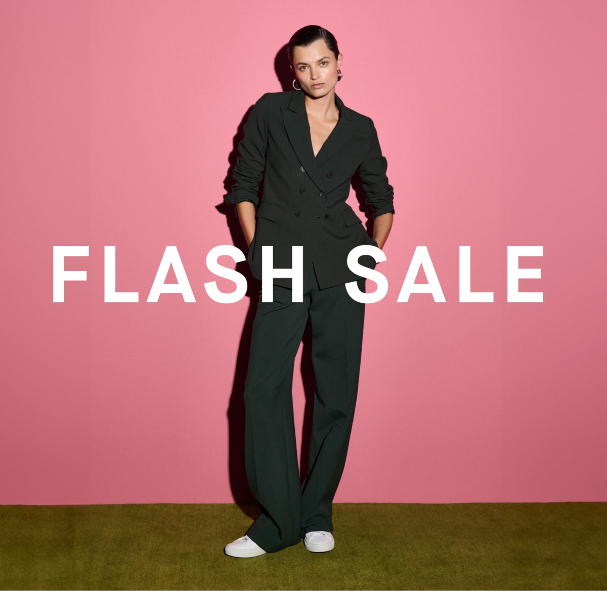 Image of a woman wearing a green suit with the words FLASH SALE