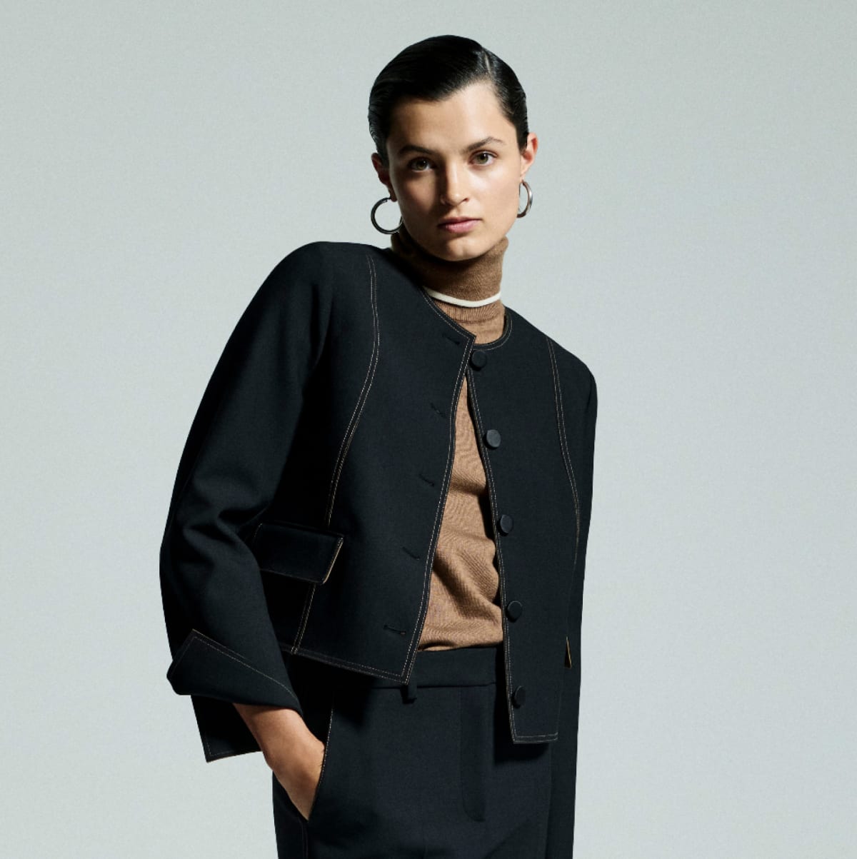 image of a woman wearing the aniya jacket in black luxe wool