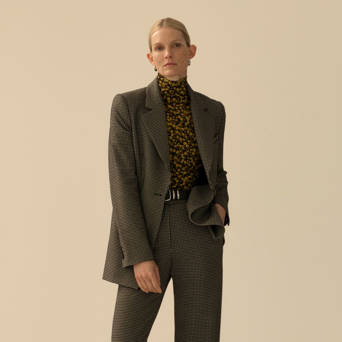 image of a woman wearing a checked suit and a floral button down