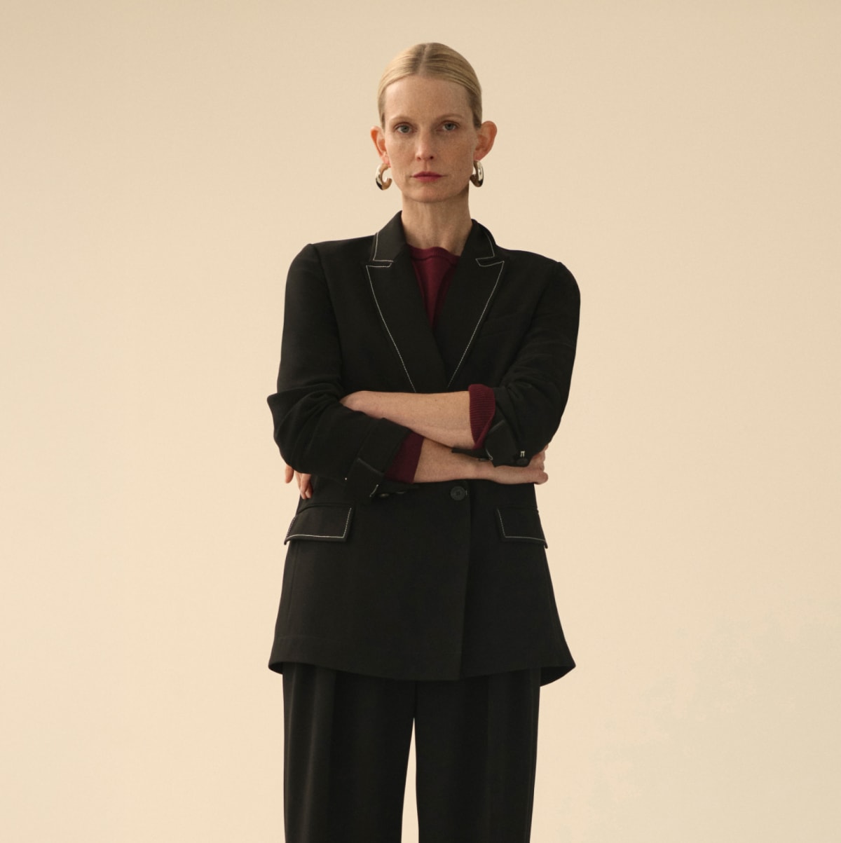 image of a woman wearing a black suit and a purple top