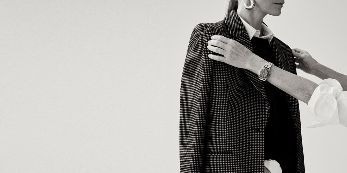 Image of a stylist adjusting a blazer on her client