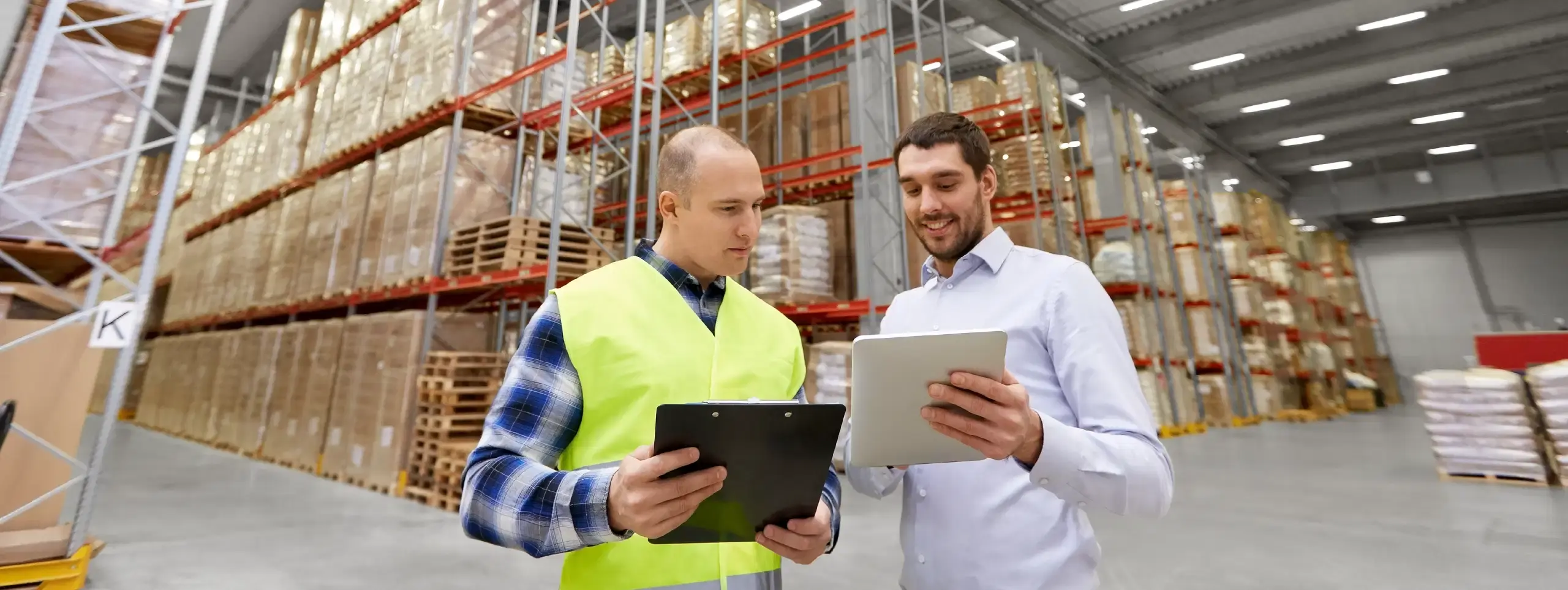 Warehouse staff reviewing operations while evaluating a 3PL WMS