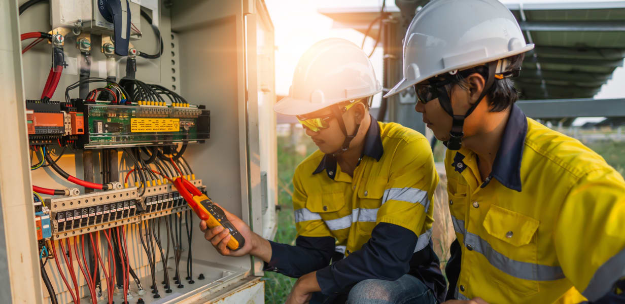 Men performing compliance and safety electrical inspection