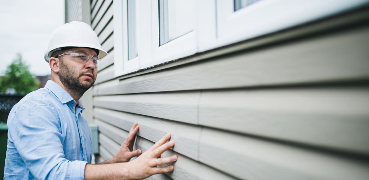 Man inspecting building