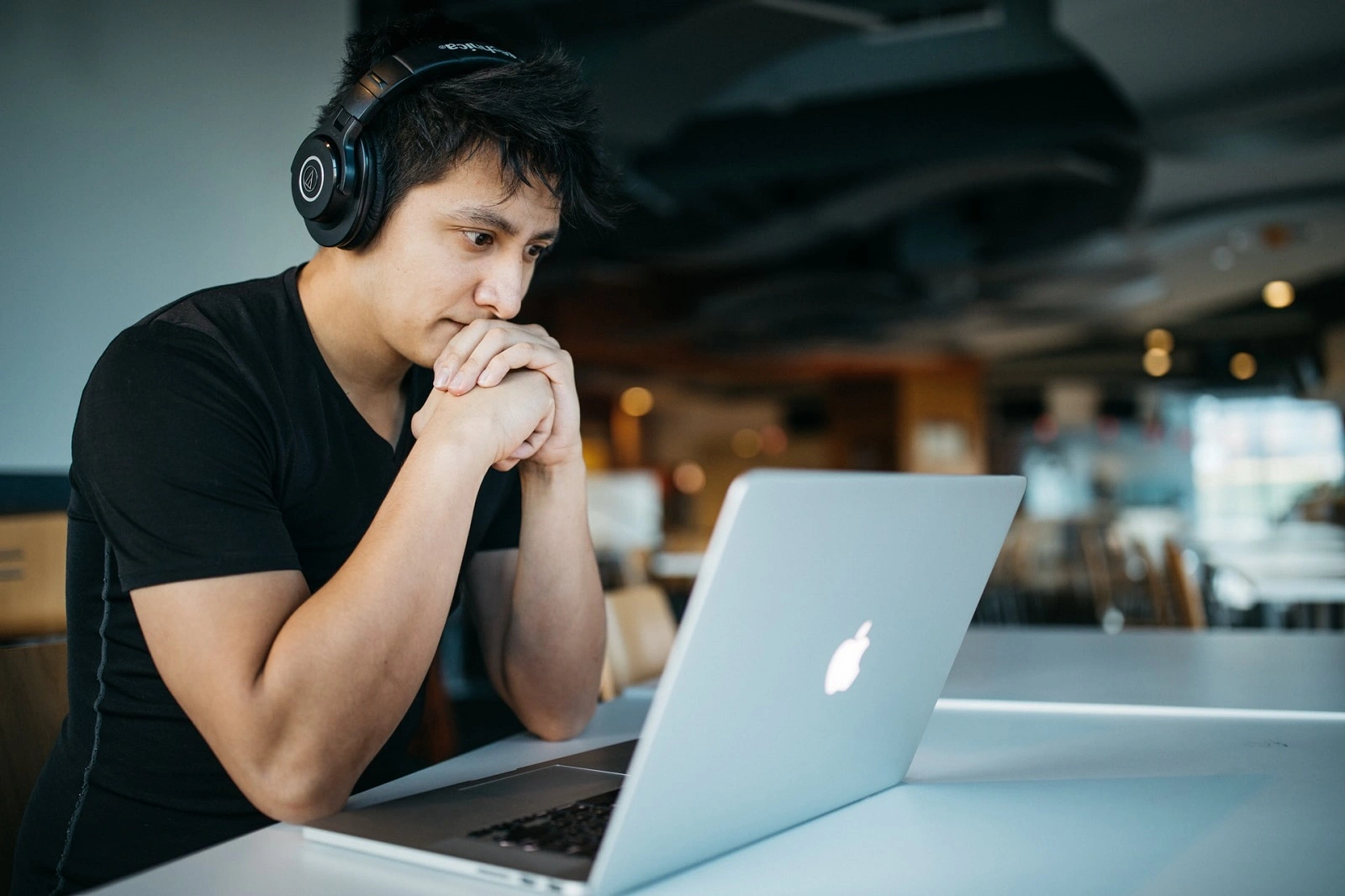 A person wonders while looking at a computer.