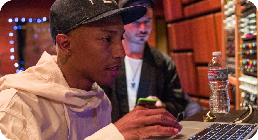 pharrell williams at a laptop