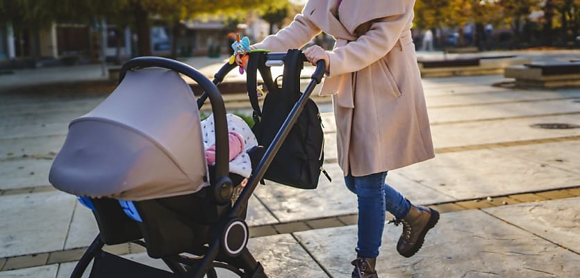 mother pushing baby pram reb xynjvn