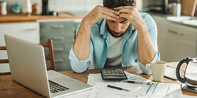 stressed man in debt ta jeahve