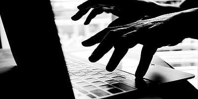 online scammer typing ad bdaqod