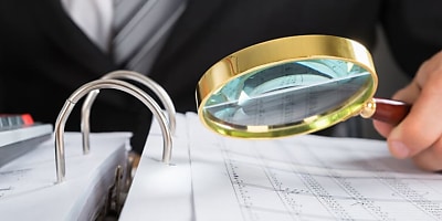 magnifying scrutiny ta