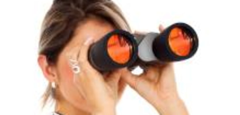 woman looking through binoculars