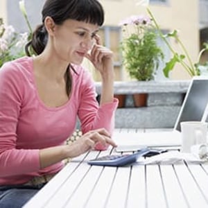womencalculating expensescalculator sstock