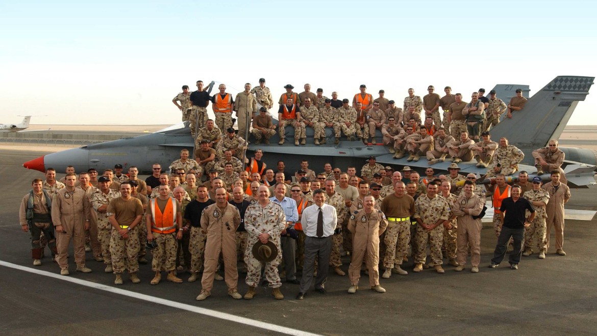 JPAU22APR03WG10 OP FALCONER Pic By: WJGCaption: Minister for Defence, Robert Hill, and Chief of Defence, General Peter Cosgrove, pose with Royal Australian Air Force personnel and an F/A-18 Hornet during a tour of the F/A-18 detachment at a Middle East base.The Minister, along with the Chief of Defence, General Peter Cosgrove, recently travelled the Middle East to visit Air Force personnel serving on Operation Falconer.Operation Falconer is the Australian contribution to the international coalition to ensure the removal of weapons of mass destruction from Iraq.