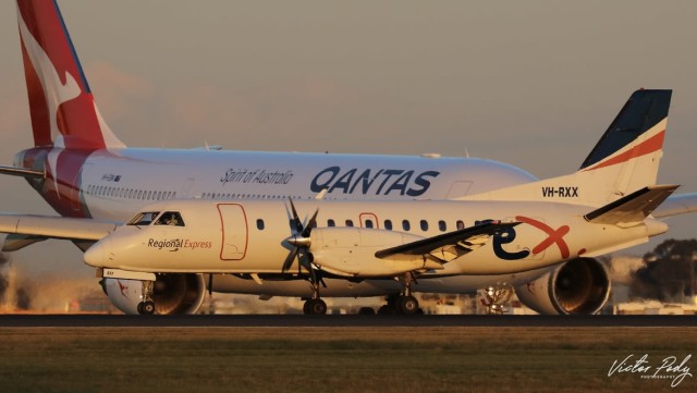 A Rex Saab 340b, VH-RXX, alongside a Qantas A330-202, VH-EBN, as shot by Victor Pody