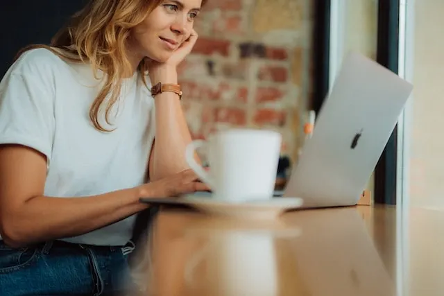 a woman looking through her Mac computer