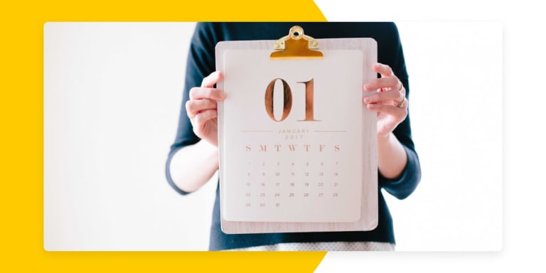 woman's hands holding up a calendar