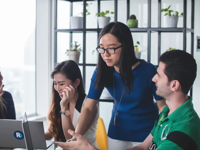 image of a woman teaching a man and girl project management