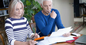 An older couple looks at a computer