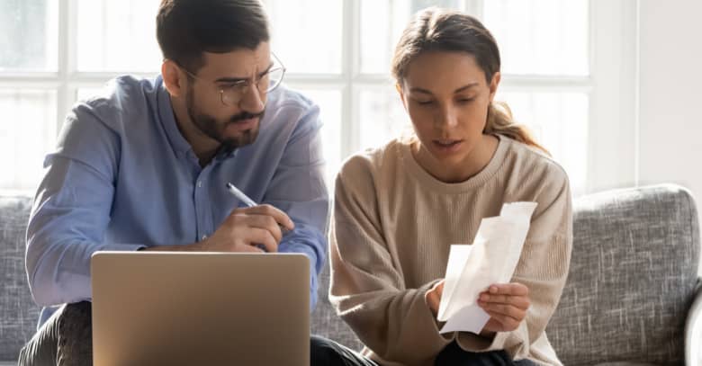 a man and woman discuss their bankruptcy options as they review their debts