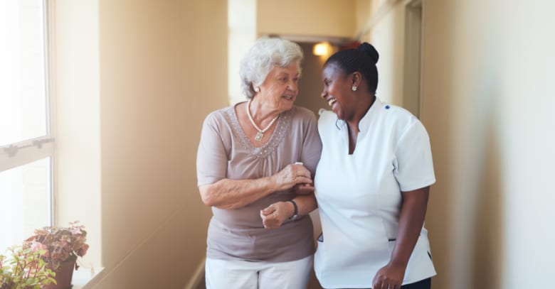 A caregiver and an assisted living resident enjoy a moment together