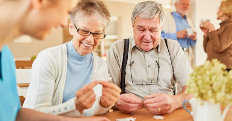 Seniors enjoy a game of cards at adult day care