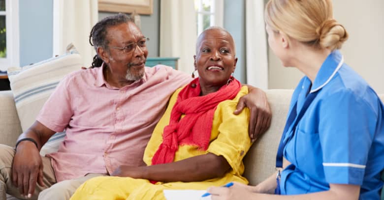 A nurse discusses care options with a senior couple