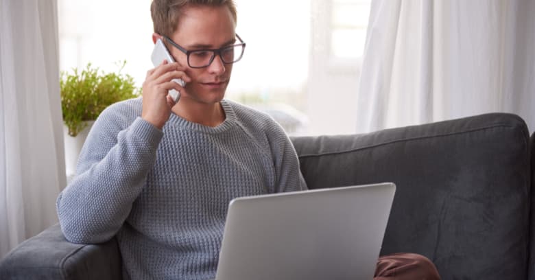 A man discusses financial assistance programs with a governmental agency representative on his phone