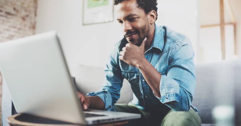 A man uses his computer to apply for a loan online