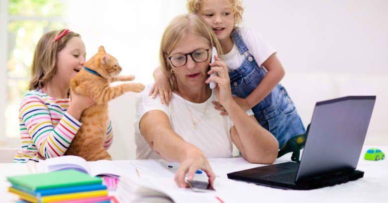 A woman is at home with her children trying to look at her computer during the coronavirus.