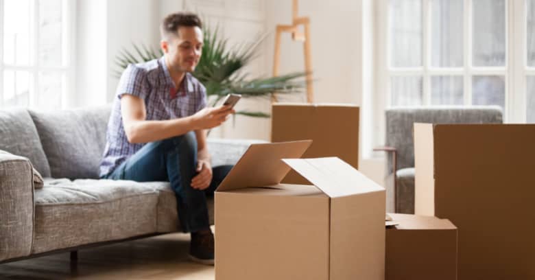 A family is surrounded by boxes in their new home