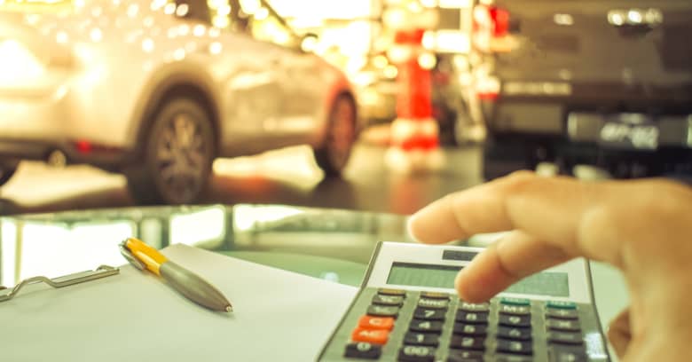 a finance manager at a car dealership figures out how much a car buyer's payments will be