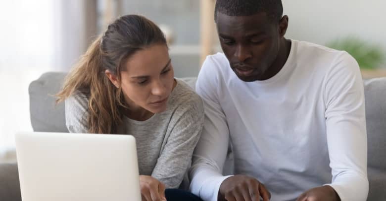 A couple looks intently at tax paperwork.