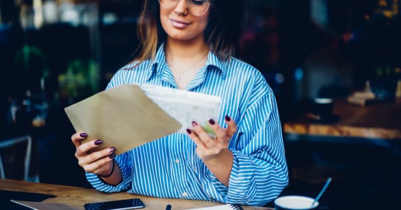 A woman stuffing an envelope.