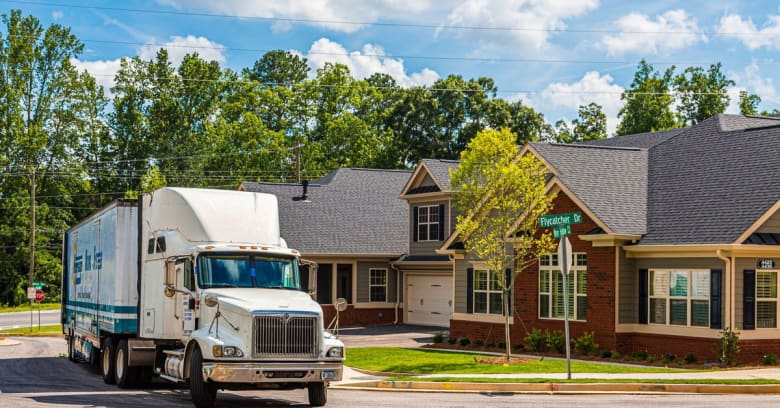 a moving truck leaves a neighborhood