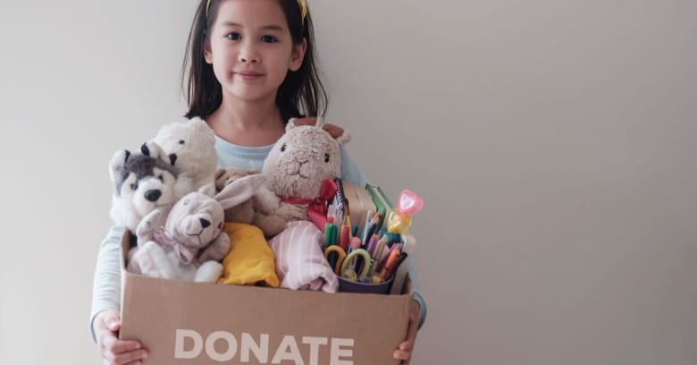 A young girl is preparing to move with her family by gathering up some of her belongings and donating them