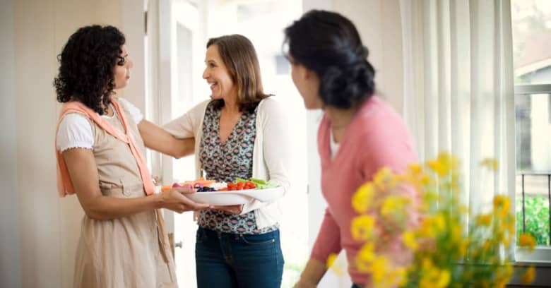 a woman welcomes some new neighbors to the neighborhood