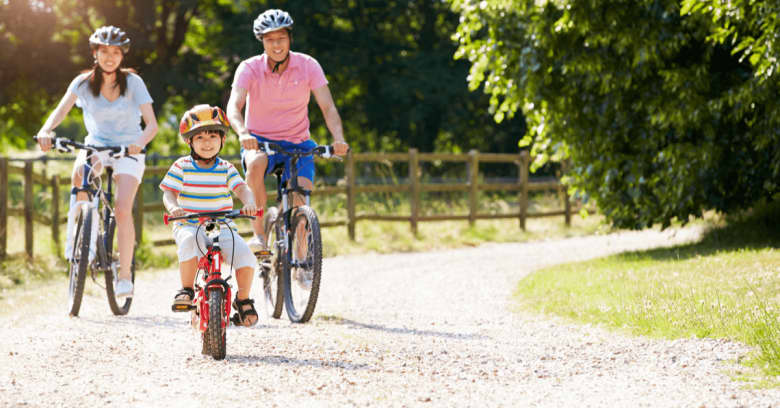 A family is out for a bike ride on a sunny day