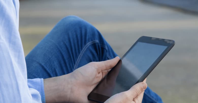 a man reads a book on an e-reader device