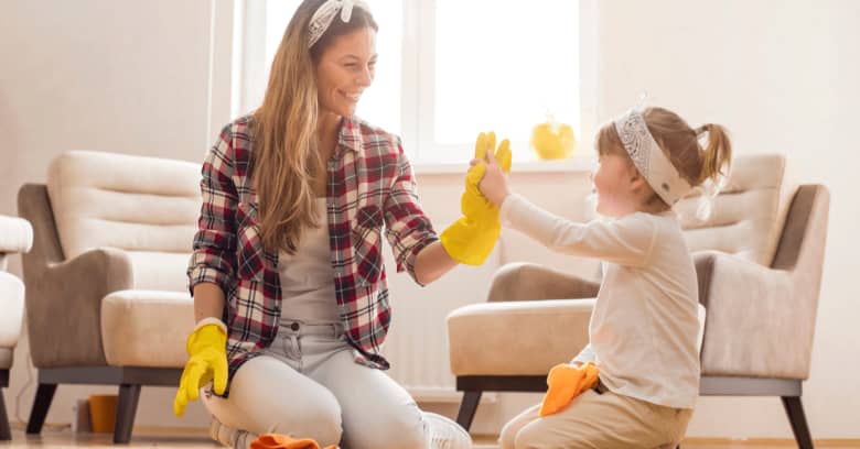 a woman and her daughter enjoy cleaning the house together