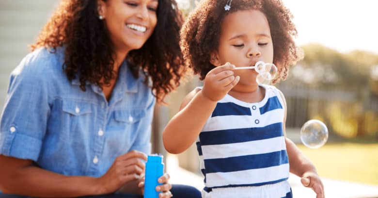 A mother and daughter enjoy some time together outside