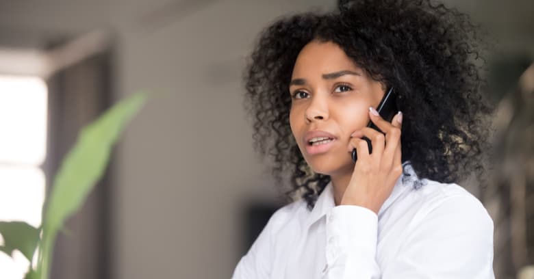 A woman has a serious phone conversation.