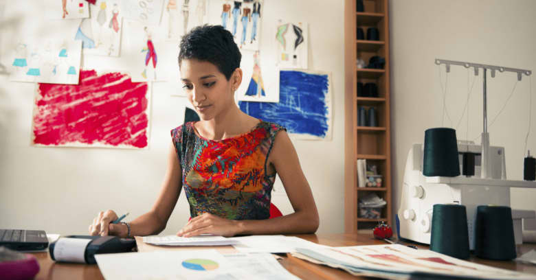 A woman who owns her own home business considers applying for a small business loan, thanks to the favorable interest rates