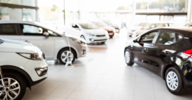 A row of new cars is seen at a dealership