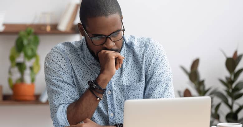 a man looks anxious while looking at a computer