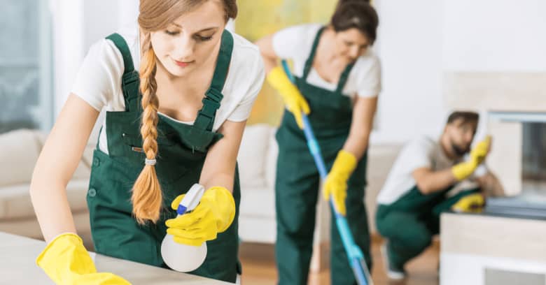 three professional cleaners are shown cleaning a home with proper cleaning equipment