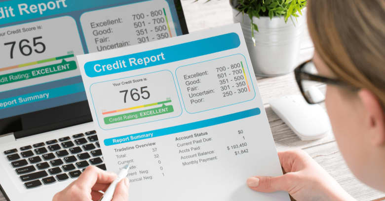 a woman in glasses looking at her credit report
