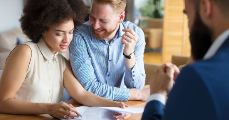 Couple discussing home loans with mortgage lender