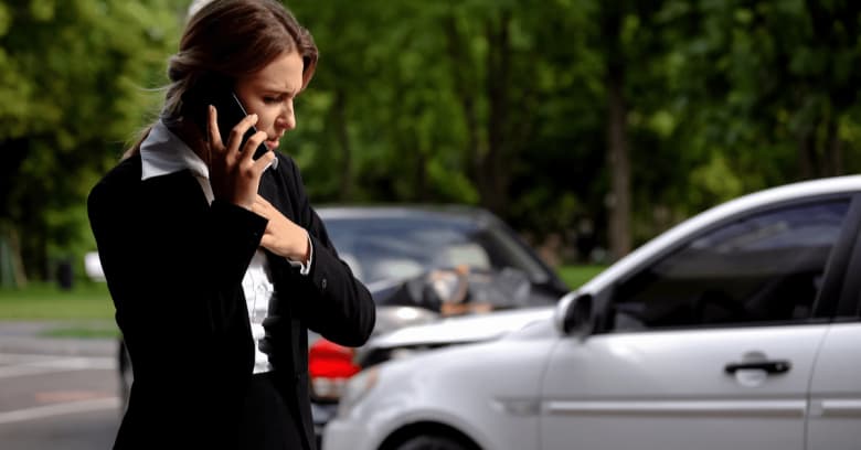 Woman after car accident trying to use her phone to call for help